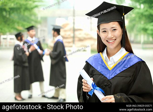 Young Female University Graduate, Portrait with Diploma