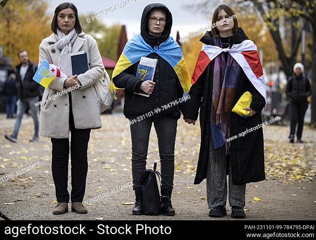 01 November 2023, Berlin: Participants hold hands. A vigil for Ukrainian children took place in front of the Russian Embassy in Berlin