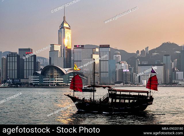 Tour boat in Hong Kong harbor at sunset