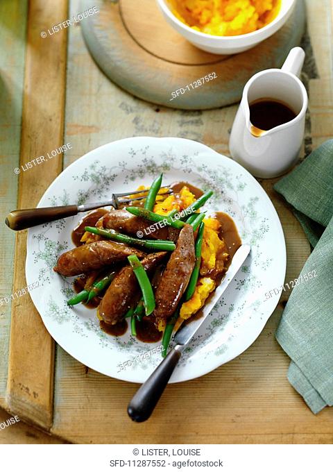 Sausages with mashed potatoes and pumpkin, green beans and gravy