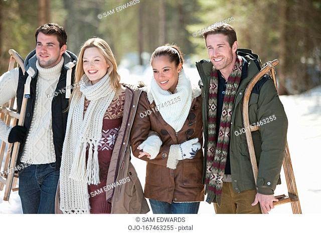 Smiling couples walking in woods