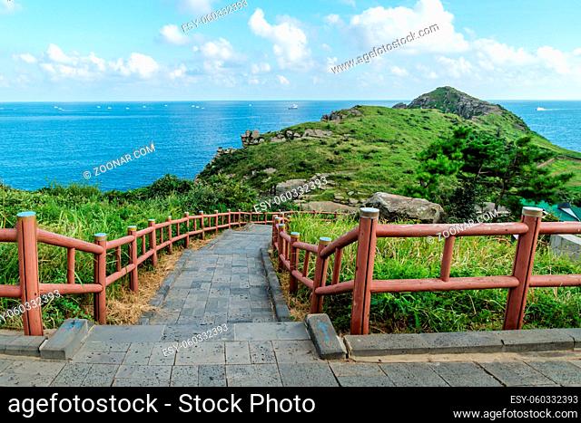Dragons head hill reaching into the ocean with path at Yongmeori Beach, Sanbang-ro, Jeju Island, South Korea