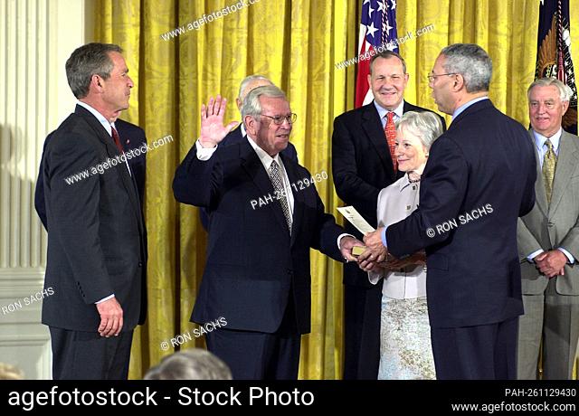 United States Secretary of State Colin Powell swears-in former U.S. Senator Howard Baker (Republican of Tennessee) as U.S