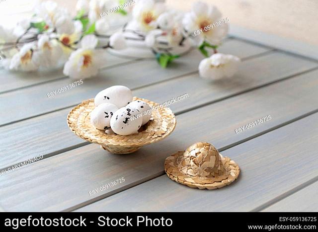 Straw hat decorated for easter with flowers and easter eggs for spring decoration