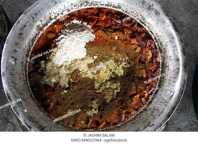 A pot full of Beef with different types of spices before it is put on the stove for cooking on the occasion of a mezban The word mezban in Persian means ‘host’...