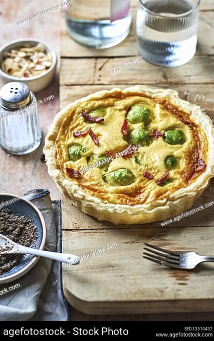 Brussels sprouts and ham tart with black olive pesto topping