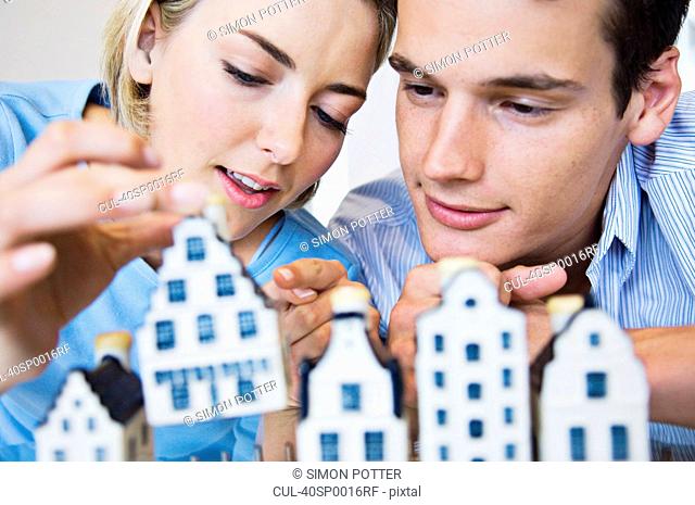 Couple examining model houses