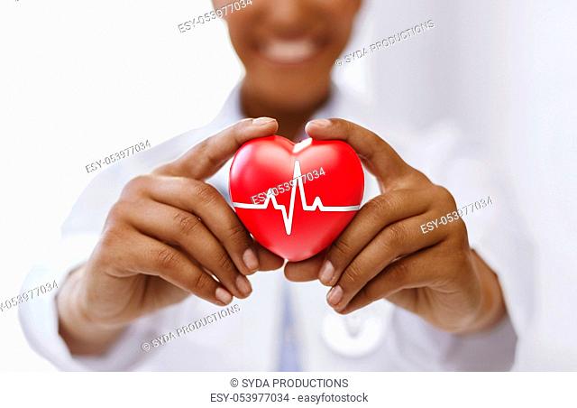 african female doctor with red heart and ecg line