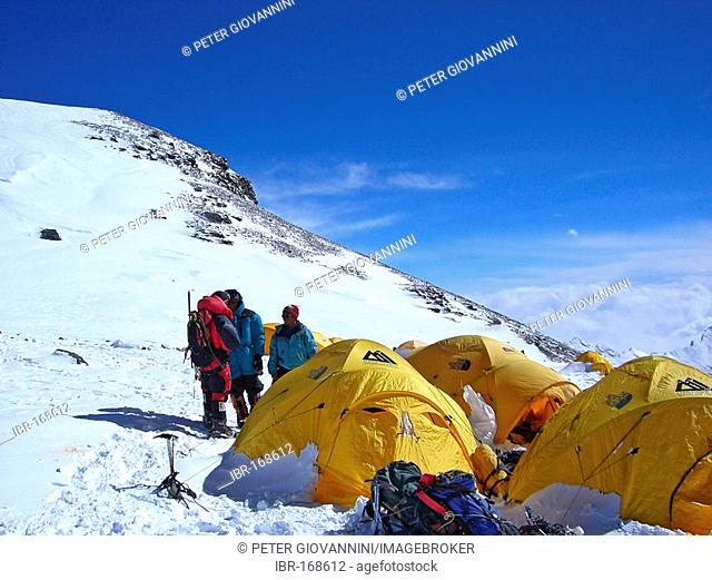 Yellow tents, alpinists and equipment in Camp IV, 4, on South Col, 7950m, Mount Everest, Himalaya, Nepal