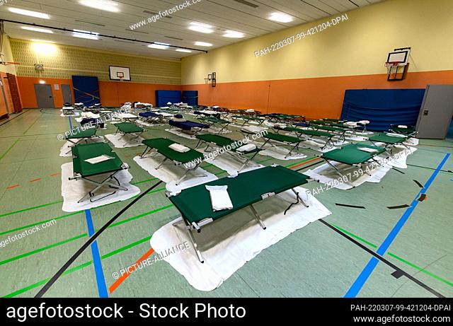 07 March 2022, Bavaria, Munich: Camp beds stand in the gymnasium of a high school near the main train station. The city of Munich has set up an emergency...