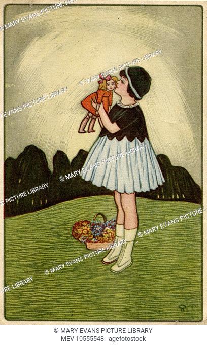 A little girl standing on a hillside, kissing her doll. She has put a basket of flowers down by her feet