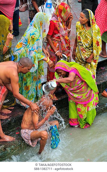 Pilgrims bathing at Har Ki Pairi ghat by the Ganges river