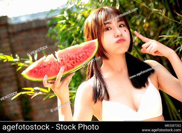 Girls eat watermelon in the outdoor