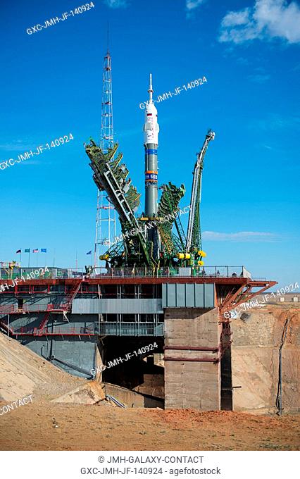 The gantry arms close around the Soyuz TMA-14M spacecraft to secure the rocket at the launch pad Sept. 23, 2014 at the Baikonur Cosmodrome in Kazakhstan