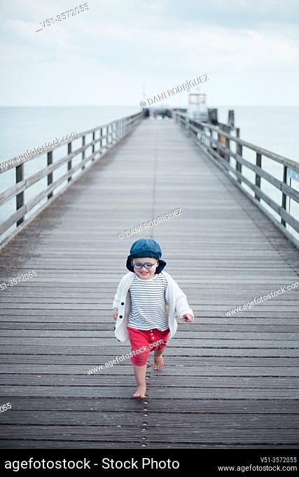 2 years old boy in a dock at the beach