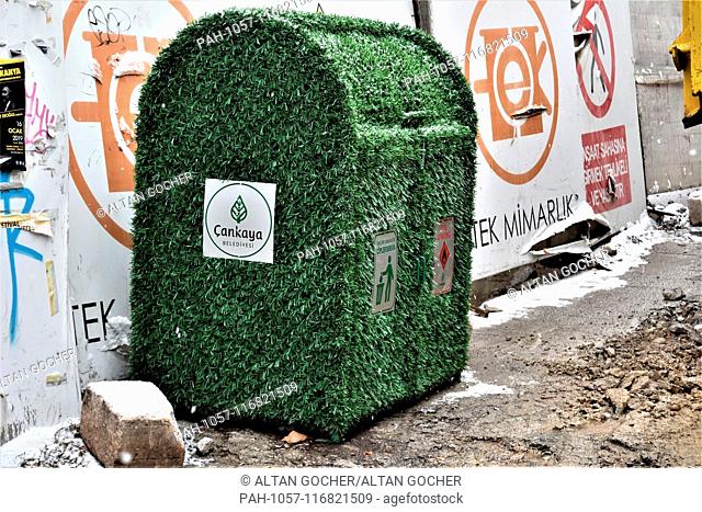 17 January 2019, Turkey, Ankara: A garbage can with a green eco-friendly design is placed next to the construction site of a building by the main opposition...