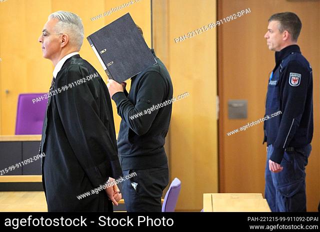 15 December 2022, Brandenburg, Neuruppin: The defendant (M) stands next to his defense attorney Morad Sehouli (l) at the beginning of the trial day in the...