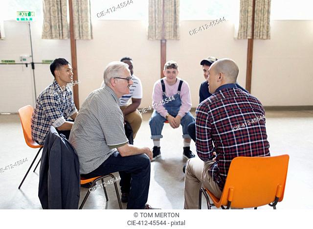 Men talking in group therapy circle