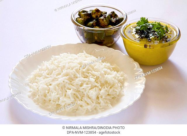 Indian cuisine boil basmati rice bhath chaval oryza sativa and fry or tadka moong dal mung beans phaseolus aureus with vegetable bhindi masala lady's finger...