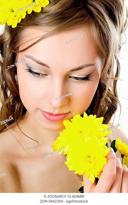 Girl with beautiful hair with yellow chrysanthemum