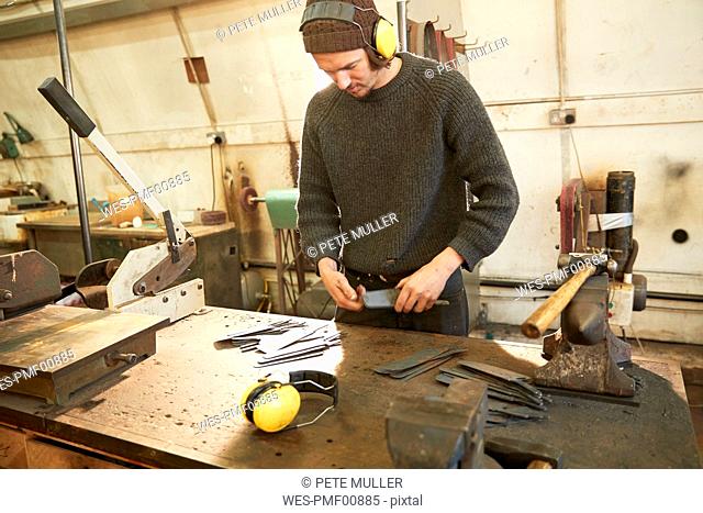 Man making knives in a workshop