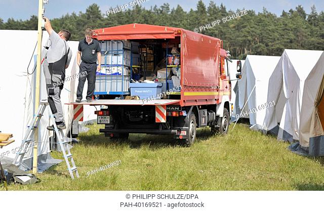 A helper of the fire department unloads a truck in a makeshift camp for helpers in Amt Neuhaus, Germany, 11 June 2013. The flood situation at the Elbe in Lower...