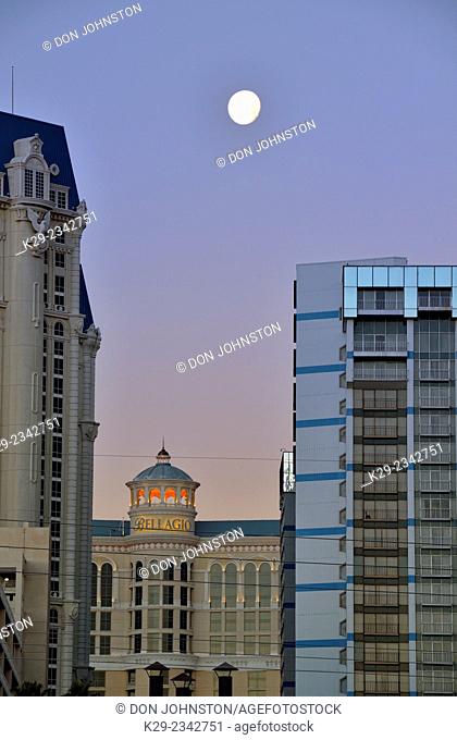 Paris Las Vegas and Bellagio resort hotels at dawn with setting moon, Las Vegas, Nevada, USA