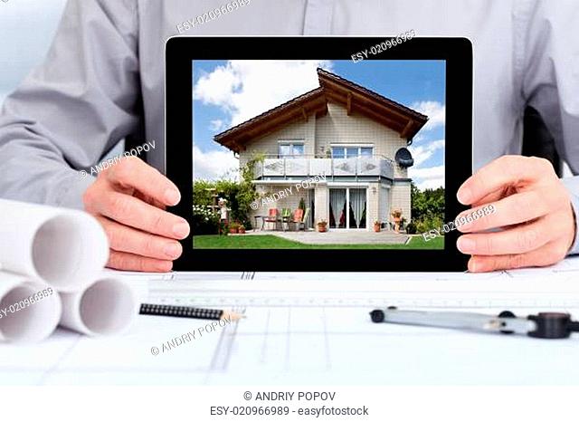 Architect Showing Picture Of House