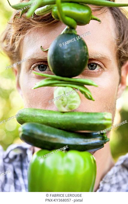 Portrait of a man holding vegetables