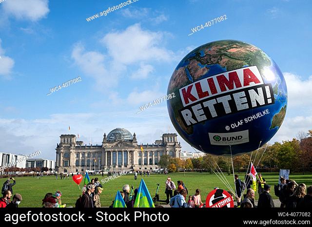 Berlin, Germany, Europe - Protesters march through the government district and pass the Reichstag Building at the protest rally ""Solidaric through the crisis""...