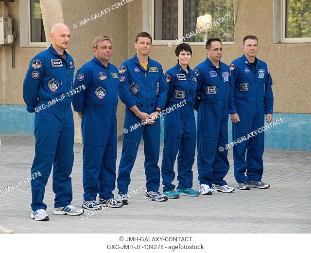 At the Cosmonaut Hotel crew quarters in Baikonur, Kazakhstan, the Expedition 4041 prime and backup crew members pose for pictures after raising the flags of...