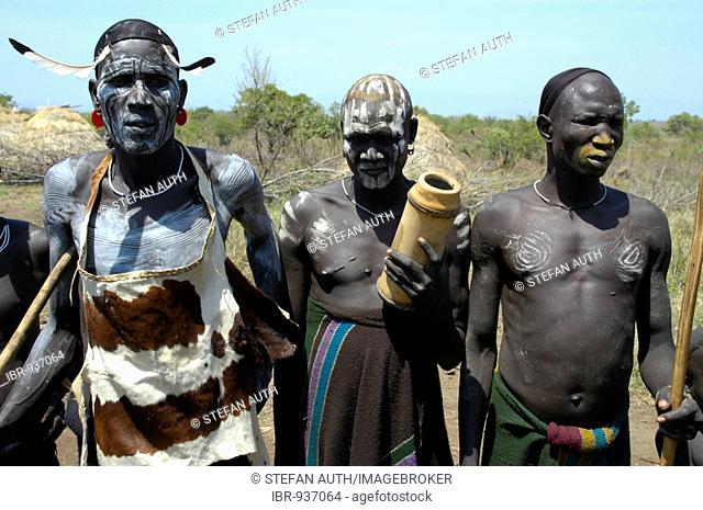 Chiefs, three men from the Mursi tribe with painted faces, near Jinka, Ethiopia, Africa