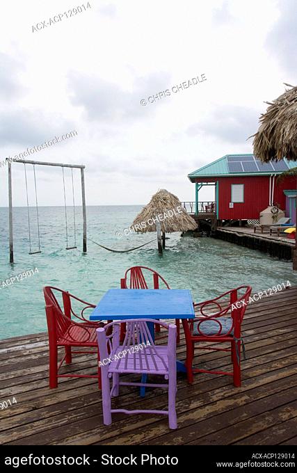 Colorful cabins and palm trees at the idyllic King Lewey's Island Resort, Belize