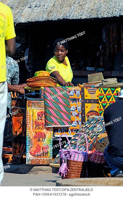 A vendor outside a souvenir store at the Victoria Falls, pictured on 30.07.2015. The Victoria Falls are the broad waterfalls of the Zambezi at the border...