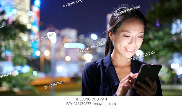 Business woman use of cellphone at night