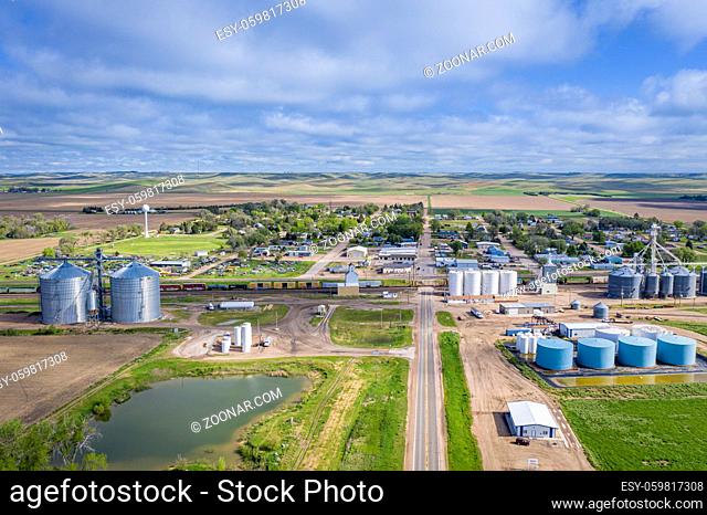 Brule, NE, USA - May m27, 2019: Aerial view of rural town in Nebraska Sandhills with agricultural industry and passing cargo train
