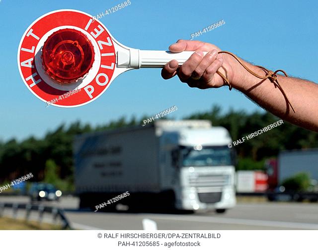 A police officer stops a truck at the A2 motorway near Brandenburg, Germany, 22 July 2013. The police headquarters West has ordered several traffic controls as...