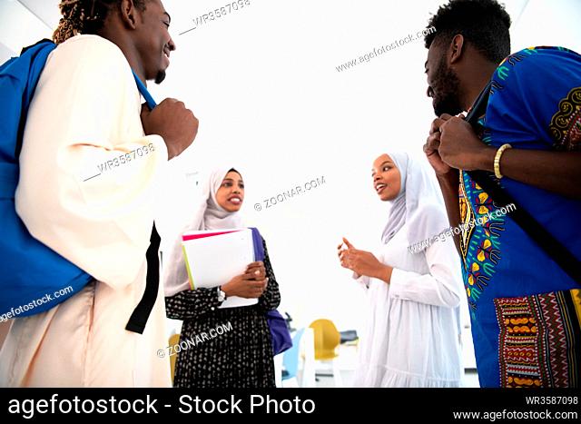 group of happy african students having conversation and team meeting working together on homework girls wearing traidiional sudan muslim hijab fashion