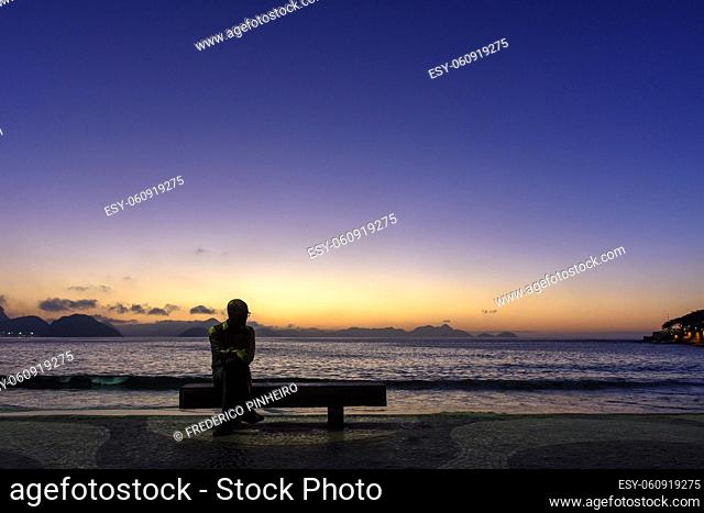 Sunrise on the famous Copacabana beach during the summer of Rio de Janeiro with its colors, horizon and the sea