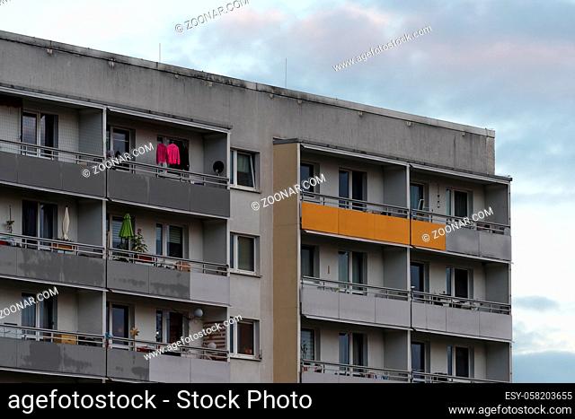 The pink hooded sweater on the balcony of the prefabricated building