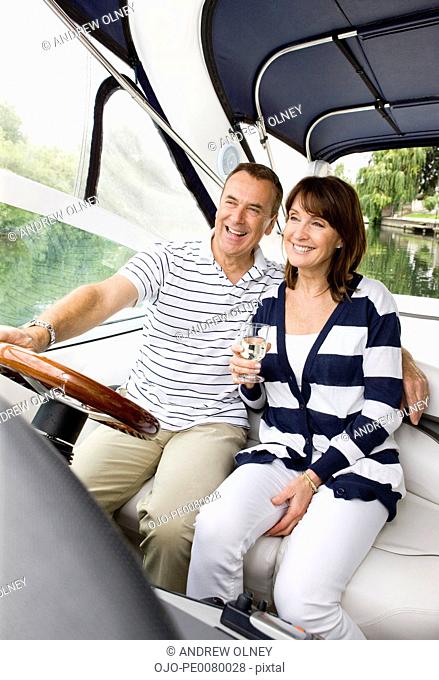 Couple riding in boat on river