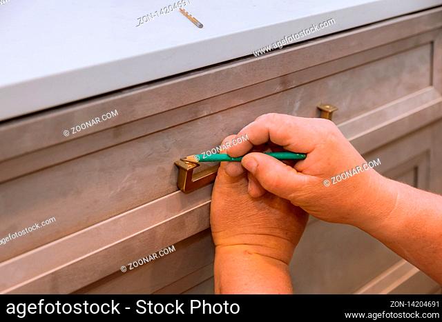 Home improvement contractor installing new custom kitchen cabinetsdrawers hinge