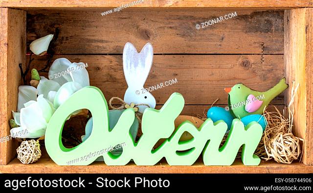 The word easter in german language with decoration in a wooden box
