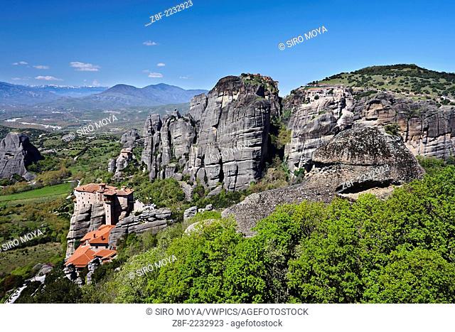 Sandstone rock pillars in Meteora with the Monasteries of St. Nicholas Anapausas on the left, Great Meteoron in the upper side and Varlaam on the right