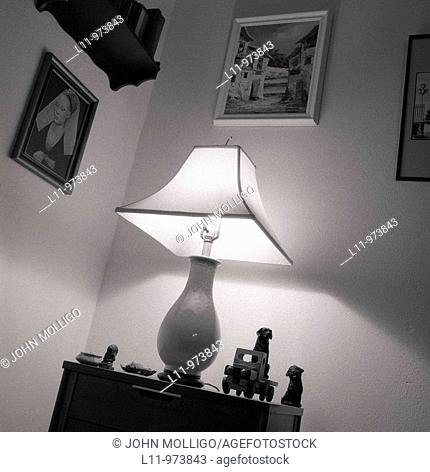 Lighted lamp on nightstand, at night