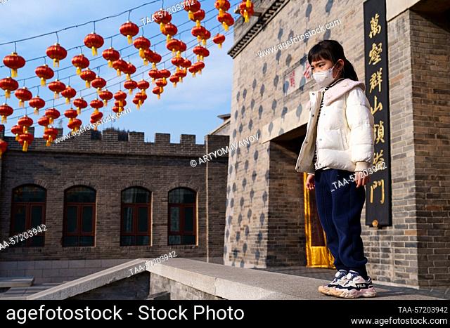 CHINA, BEIJING - FEBRUARY 5, 2023: A girl walks in Gubei Water Town during the Lantern Festival. The Lantern Festival, a Chinese traditional festival celebrated...