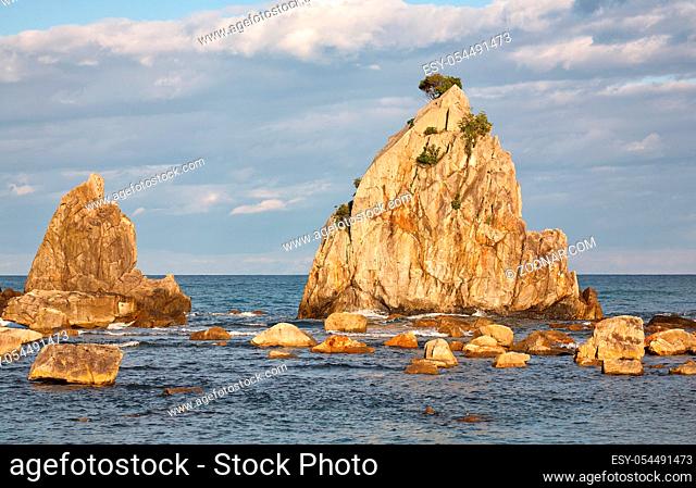 Hashigui-iwa (Bridge Pillar Rocks) - the series of rocks leading towards Oshima Island near Kushimoto at the sunset light. Wakayama prefecture. Honshu