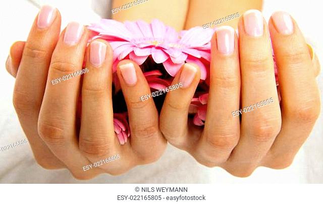 feminin hands with a treatment doing a manicure closeup