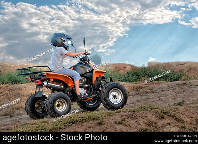 quad bike on a dirt road (all logos, inscriptions and markings removed)