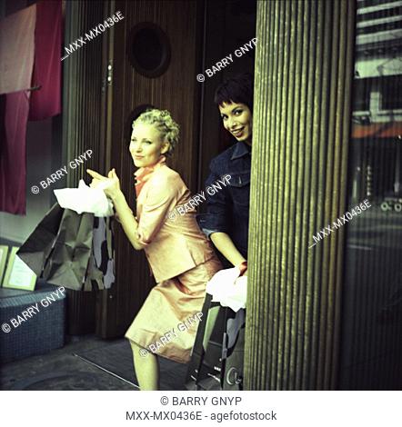 Two women shopping on Robson St., Vancouver, B.C